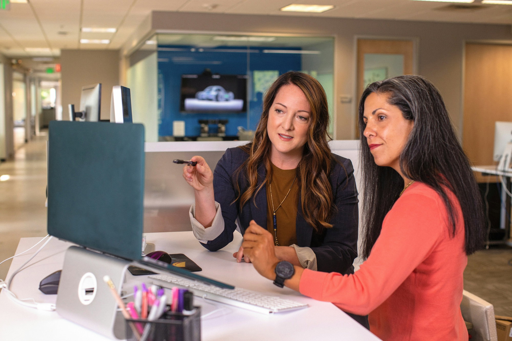 two-women-sitting-at-a-table-looking-at-a-computer-screen.jpg two women sitting at a table looking at a computer screen